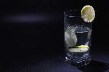 Lime water. Drinking water with fresh lime. Mineral water. Healthy, mineral-rich, refreshing water with lime.