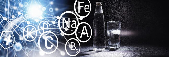 Obraz premium Close up pouring purified fresh drink water from the bottle on table in living room. Drinking water. Mineral vitamin water. Healthy, mineral-rich, refreshing water.