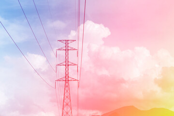 Cotton candy & puffy fluffy white clouds & cumulus cloudscape on Gradient yellow pink & blue sky background with high voltage electricity tower in tropical summer or spring sunlight & sun rays   