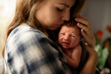 Fototapeta na wymiar Mom holds in her arms her newborn son.