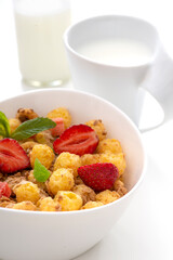 Mueslis with berries in a  white cup on the table, macro