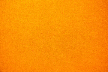 Bright solid color background. Empty orange surface with fine texture. Preparation for designer or...
