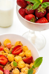 Mueslis with berries in a black white cup on the table, macro