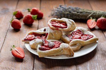 Puff with fresh strawberries on a wooden table