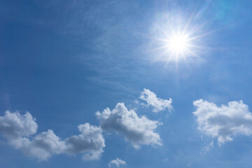 Naklejka na ściany i meble Blue sky white clouds with halo pentagram shiny sun on sunny day,copy space
