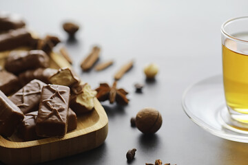 Chocolate bars on a black background in backlight. Chocolate with filling. Sweet sweets for snack and tea.