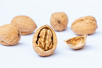 still life with Walnut kernels and whole walnuts on rustic table