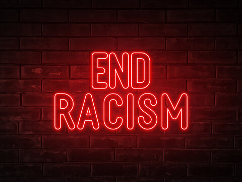 End racism - red neon light word on brick wall background