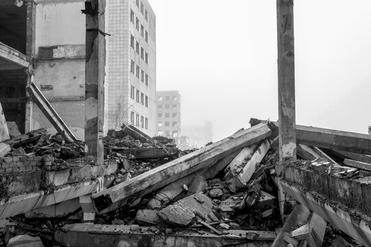 Black and white image. The destroyed big concrete building in a foggy haze. Background.