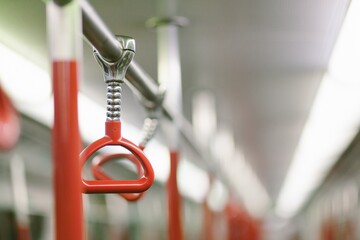 Red handrails in the subway train