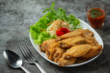 Fried wings with fish sauce, beautifully decorated herbs and served.