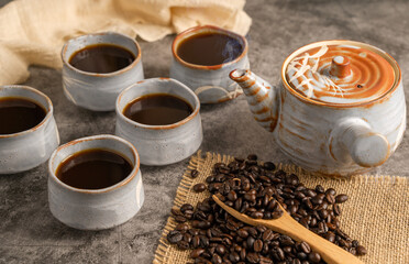 Japanese kettle and coffee beans on Old Table.