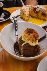 Very Delicious Italian Desserts On A White Plate On A Wooden Table With A Fork