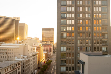 Sunset over buildings in city center Cape Town South Africa with reflections of table mountain in window