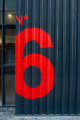 big red number six 6 on corrugated metal wall