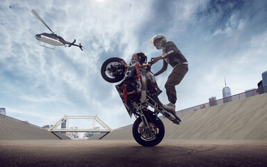 Moto rider making a stunt on his motorbike. Biker doing a difficult and dangerous stunt.