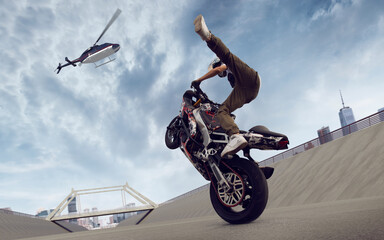 Moto rider making a stunt on his motorbike. Biker doing a difficult and dangerous stunt.