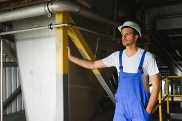 Portrait of factory worker. Young handsome factory worker.