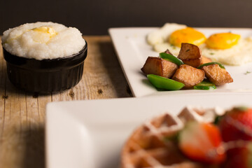 Breakfast Belgium waffle side of eggs potato grits and cappuccino coffee