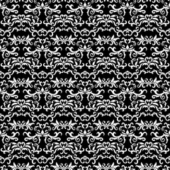 Seamless pattern with ornate Damask ornament on a black background. Design of curls and plant elements. Ideal for textile print and wallpapers.