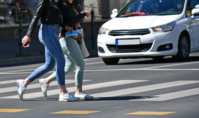 Women are walking on the pedestrian crossing