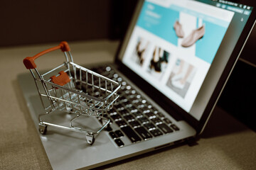 Trolley shopping cart on a laptop keyboard. Ideas for shopping online or e-commerce from internet.