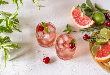 Mocktail with pink syrup and sweetened cherry