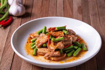 Stir fried pork belly and red curry paste with sting bean