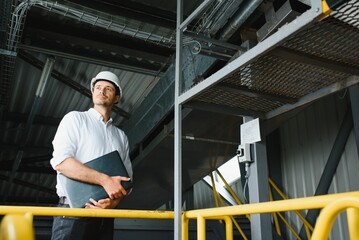 Fototapeta na wymiar happy male industrial technician inside a factory