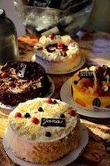 Four beautiful birthday cakes bearing the names. Close up.