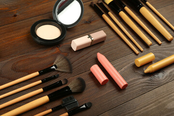 background with makeup brushes top   view on dark wooden surface
