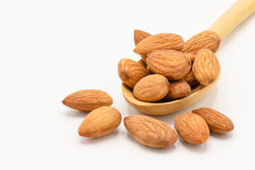 Almond nuts in a wood spoon isolated on white background, Selective focus. Is a healthy food Rich in vitamins Fiber and Antioxidants.