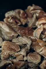 Pieces of meat are fried in oil. Large clan. Selective focus