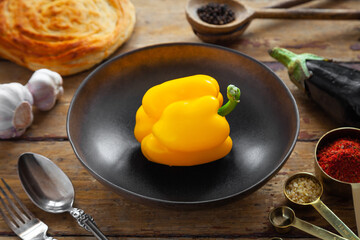 Pilaf ingredients, rice, vegetables, pita, cutlery, spices on rustic background