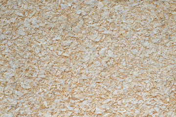 Wood sawdust texture solid background. Hamster animal bedding close up