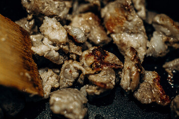 Pieces of meat are fried in oil. Large clan. . Home Cooking. Selective focus