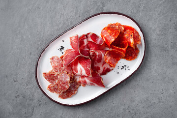 Meat appetizer plate, assortment of antipasti meat, jamon, chorizo, pepperoni, prosciutto Meat appetizer plate, assortment of antipasti meat, jamon, chorizo, pepperoni, prosciutto