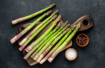 
Raw green asparagus on a stone background 