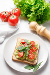 Avocado toast with cherry tomatoes and arugula.