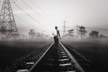 man walking on railroad