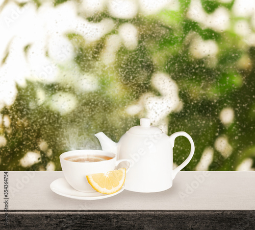 Teapot And Cup Of Hot Tea With Lemon Near Window On Rainy Day Wall Mural New Africa Teapot And Cup Of Hot Tea With Lemon Near Window On Rainy Day Wall Mural New Africa