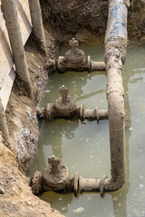 Used muddy water pipe valve in a trench