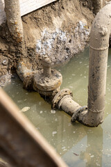 Used muddy water pipe valve in a trench