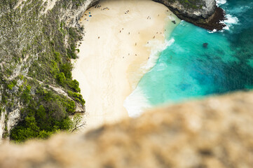 (Selective focus) View from above, stunning aerial view of a T-Rex shaped cliffs with the beautiful Kelingking Beach bathed by a turquoise sea. Nusa Penida, Indonesia..