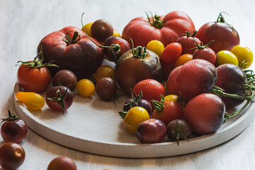 yellow and red cherry tomatoes on old white wooden table