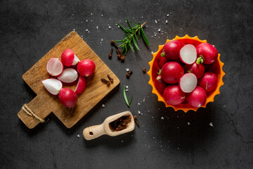 top view of red radishes on gray gradient background