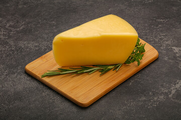 Hard cheese piece served rosemary