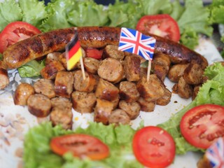 grilled meat with vegetables German sausage grilled on dish decorate with England and German flag appetizer for drinking beer party on big match football