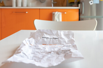 A crumpled sheet of paper with a diet.