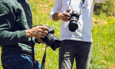 Two photographers talk in nature